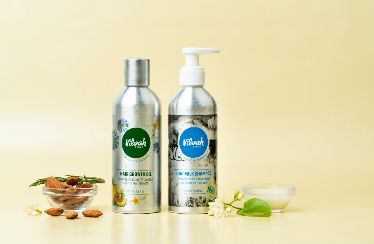 services-03 Natural hair care products featuring goat milk shampoo and hair growth oil on a yellow background.